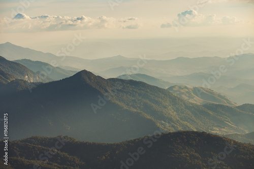 Smoky mountain landscape with mountain and light rays before sunset.
