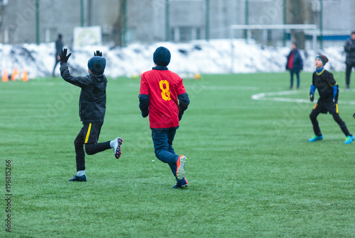 two football teams play on the winter stadium © Natali