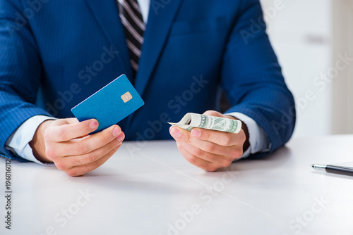 Businessman holding dollar money and credit card