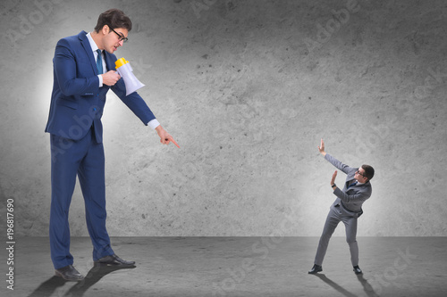Bad angry boss shouting at employee with loudspeaker