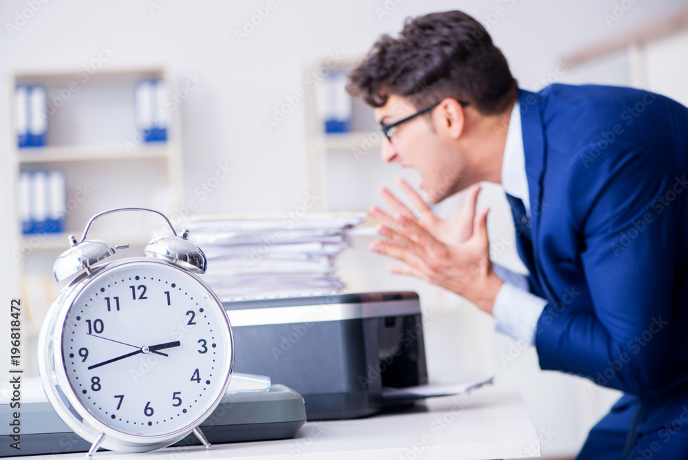 Businessman making copies in copying machine Businessman making copies in copying machine