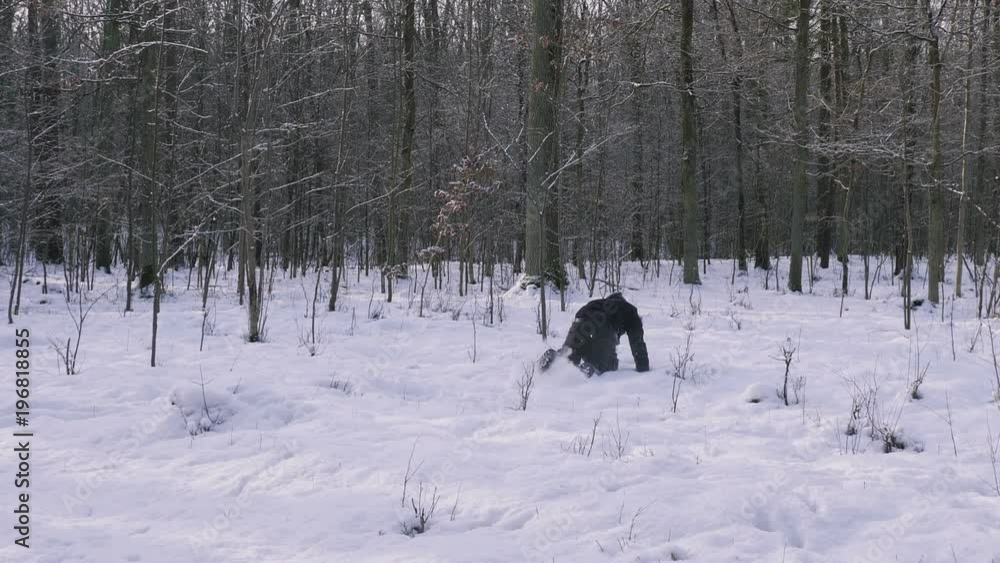 Man runs like crazy through the forest in the winter. Man runs like crazy through the forest in the winter.