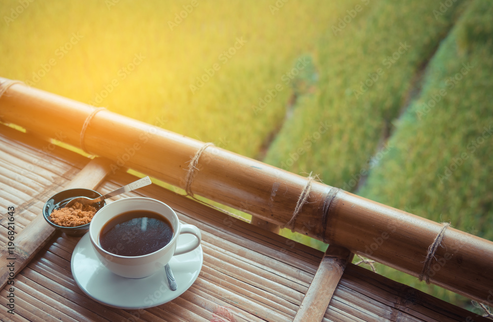 black coffee in white cup on wooden table.