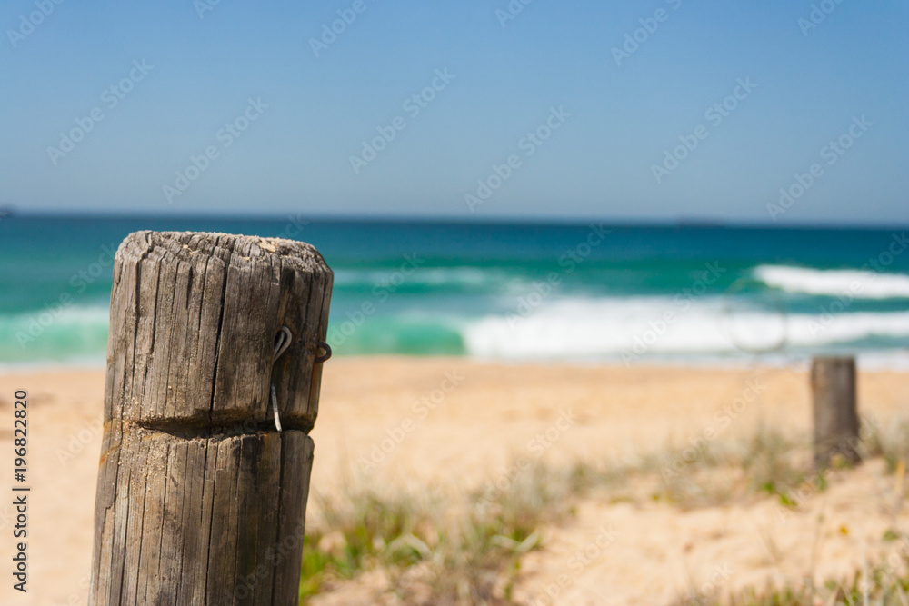 Close up of fence post at surfing beach on a sunny day Close up of fence post at surfing beach on a sunny day