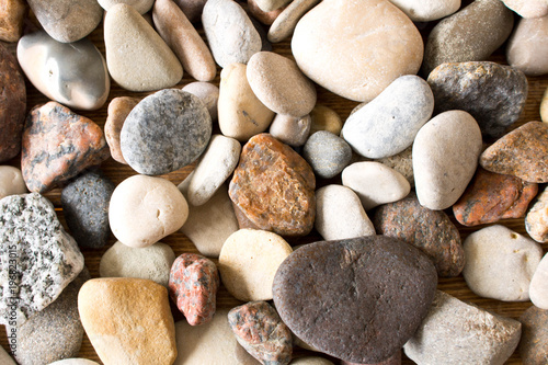 A lot of sea pebbles scattered around the table