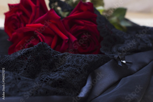 Red roses on a black lace lingerie © Maksim