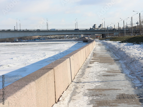 embankment in the snow and a frozen river © Andrey