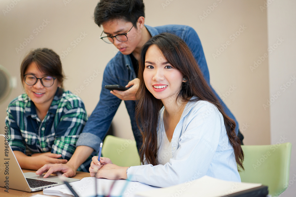 close up asian student woman smiling and working team classmate for research final project at campus university concept close up asian student woman smiling and working team classmate for research final project at campus university concept