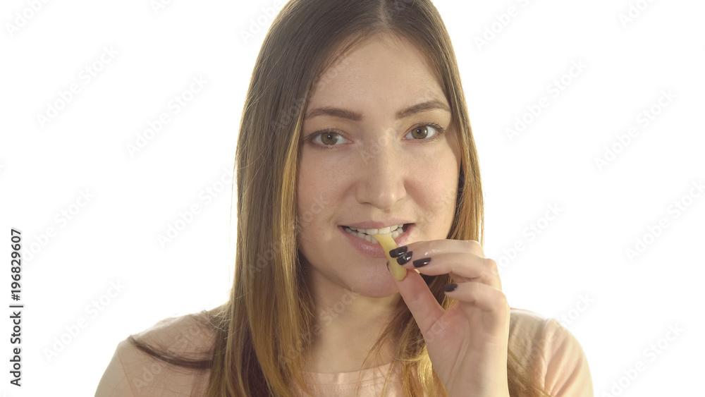Young woman eating fried potatoes, harmful food Young woman eating fried potatoes, harmful food