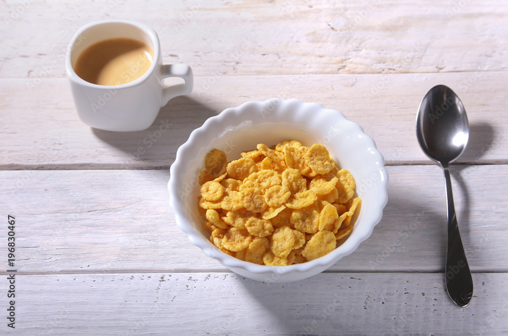 Corn Flakes cereal in a bowl and cap with espresso coffee. Morning breakfast. Corn Flakes cereal in a bowl and cap with espresso coffee. Morning breakfast.