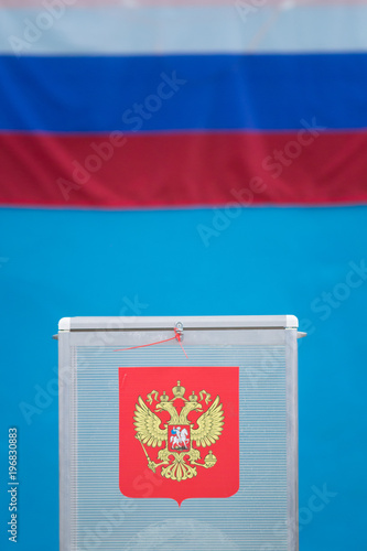 Presidential election - voting box with ballot papers in front of Russian flag photo