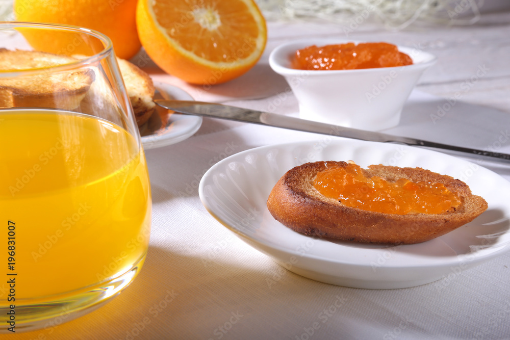 Morning Breakfast set with orange jam on bread toast and juice in glass. Morning Breakfast set with orange jam on bread toast and juice in glass.