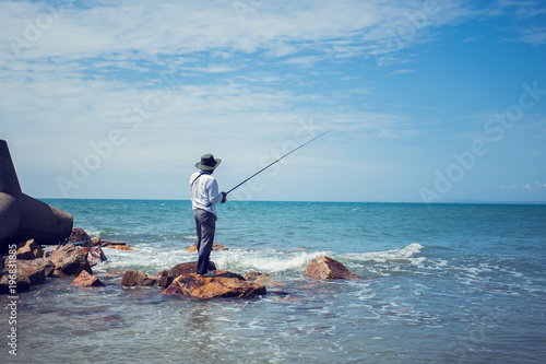 fisherman fishing in the beach sunny day