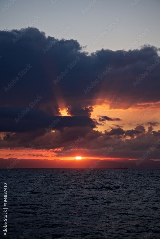 Colored sunset sky with beauty clouds and sun rays. Abstract seascape. Colored sunset sky with beauty clouds and sun rays. Abstract seascape.