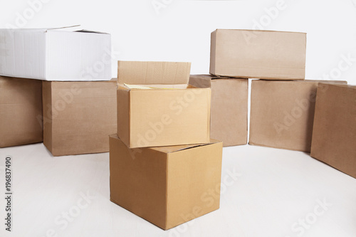 Many cardboard boxes isolated on white background © vera7388