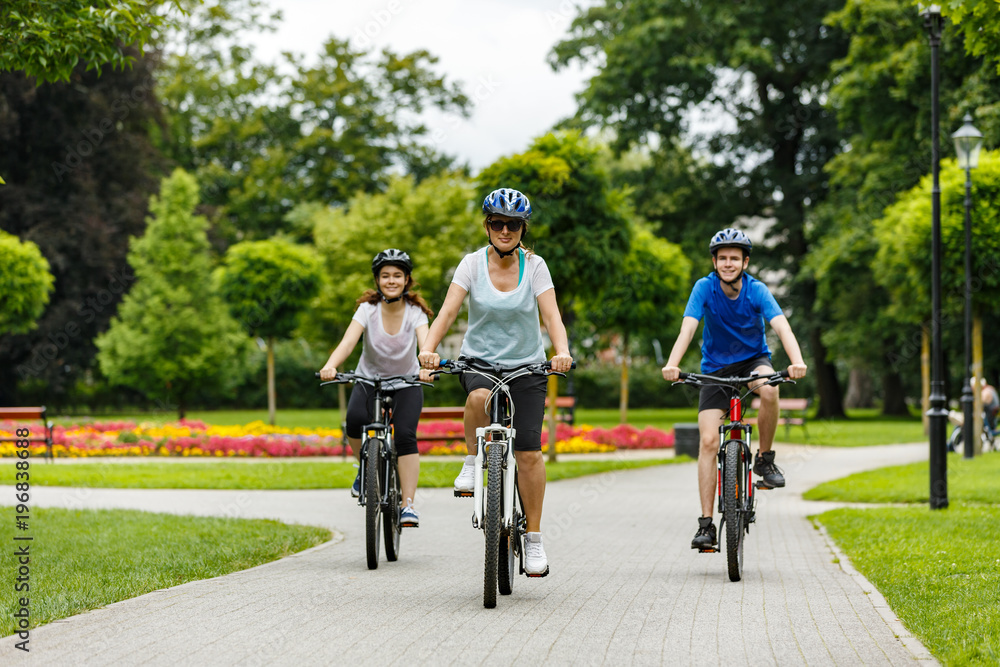 Healthy lifestyle - people riding bicycles in city park Healthy lifestyle - people riding bicycles in city park