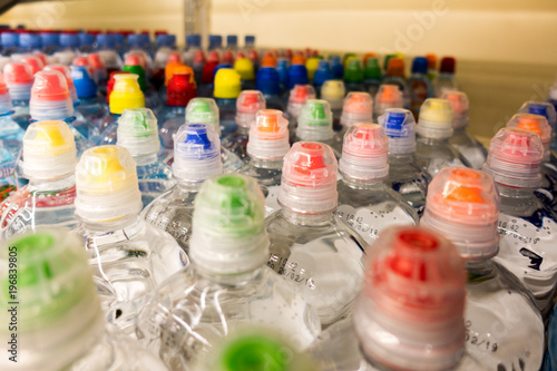 plastic bottles with water, color caps