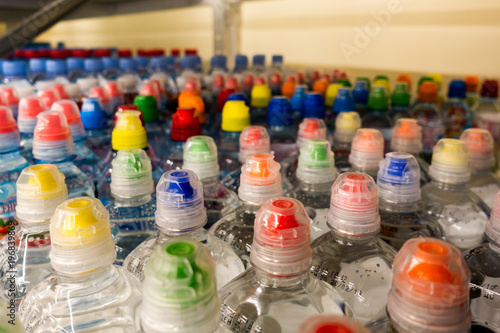 plastic bottles with water, color caps