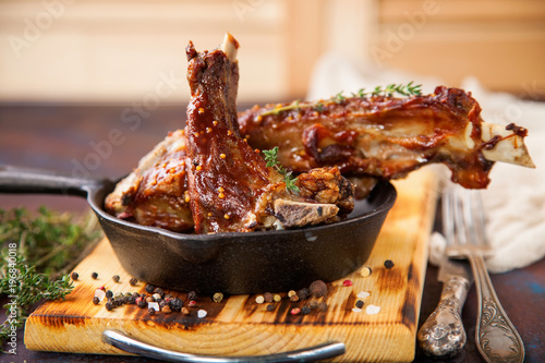 Raw meat on a rib on a board. Selective focus. Copy space. photo