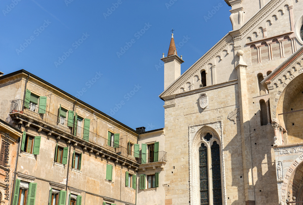 cathedrals of Verona / Detail of the gothic cathedral of Verona and neighboring building with green shutters 
