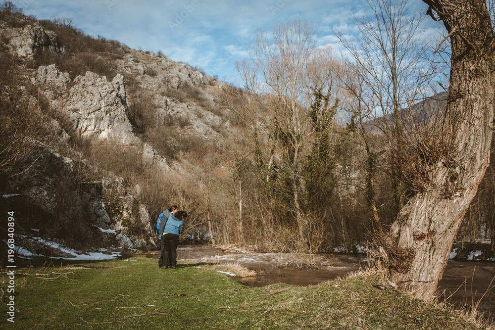 Young couple in love traveling, hiking, sporting by the river Young couple in love traveling, hiking, sporting by the river