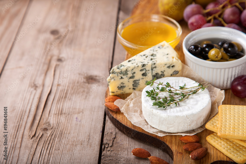 Cheese, honey and fruit on a table. Selective focus. Copy space. Cheese, honey and fruit on a table. Selective focus. Copy space.