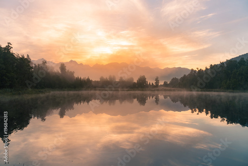 Sunrise over reflection Matheson water lake, New Zealand natural landscape background