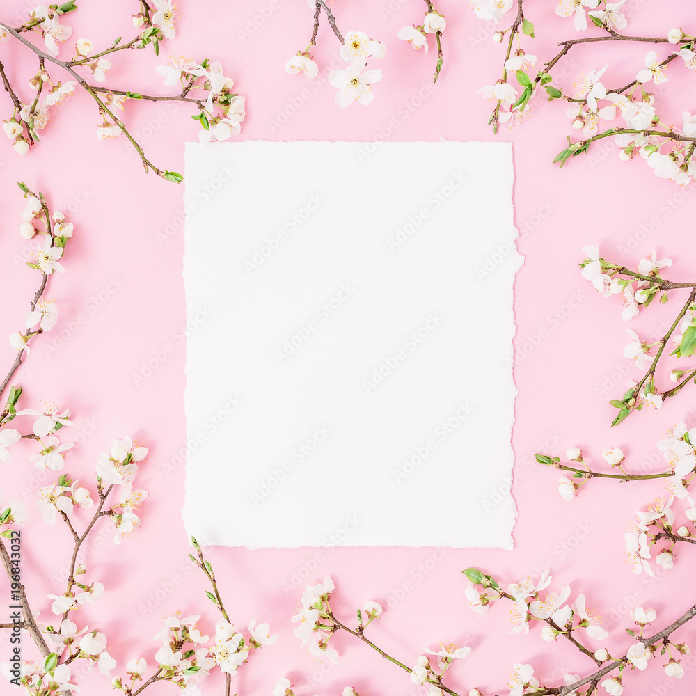 Round frame with spring flowers and white paper vintage car on pink background. Flat lay, top view. Round frame with spring flowers and white paper vintage car on pink background. Flat lay, top view.