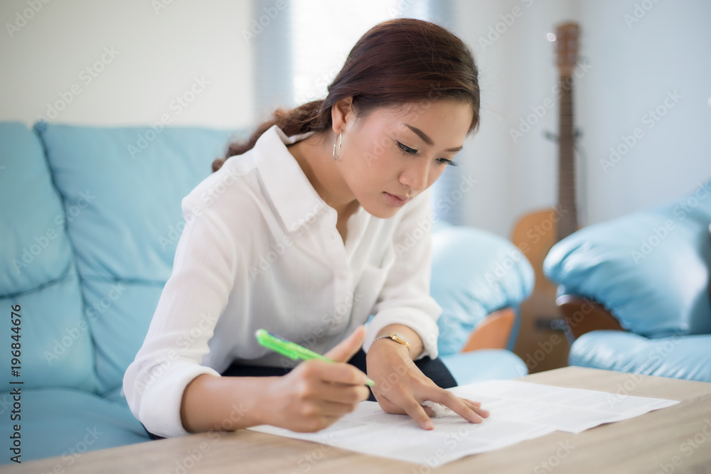 beautiful Asian business women writing data checking document and smiling happy for working beautiful Asian business women writing data checking document and smiling happy for working