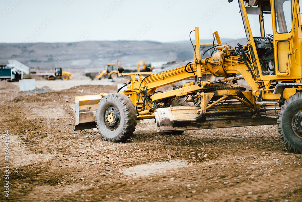Obraz premium Industrial road construction site, highway building. Heavy duty machinery working on site