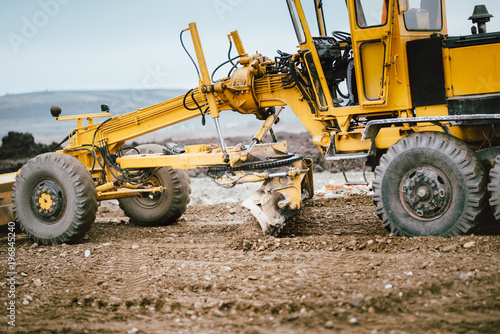 highway construction site development with motor grader moving earth  soil