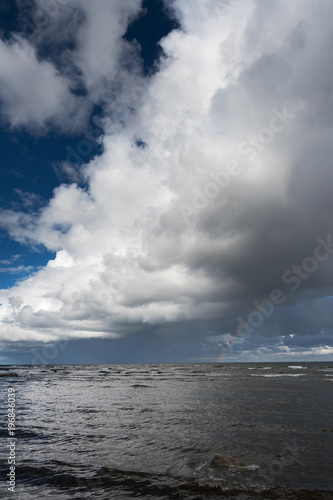 Clouds and rainbow over gulf of Riga, Baltic sea. © Janis Smits