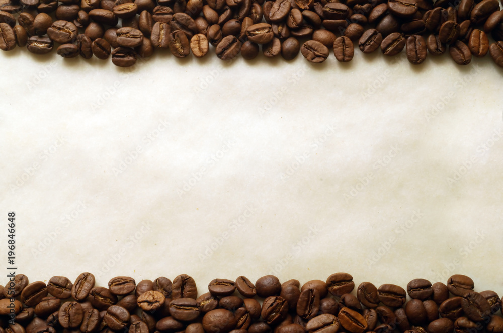Coffee beans on old burnt paper background