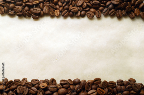 Coffee beans on old burnt paper background © rdaniluk