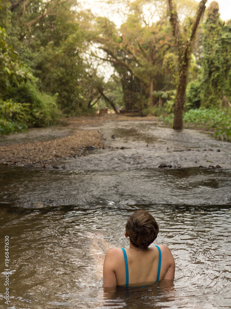Fototapeta premium woman sitting alone in lake peachful relaxation with nature travel destination journey to meditation