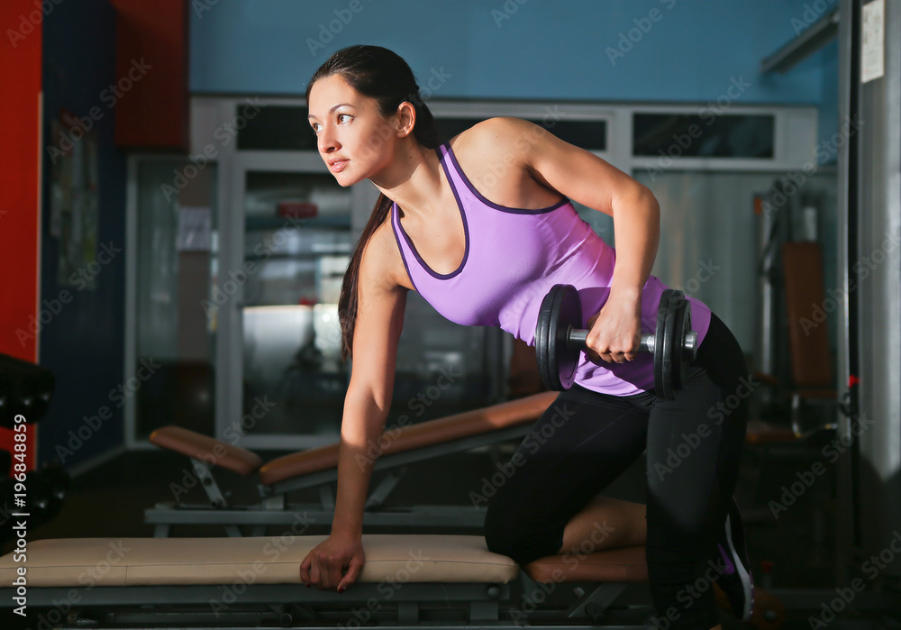 Obraz premium girl riders gym doing muscle exercises