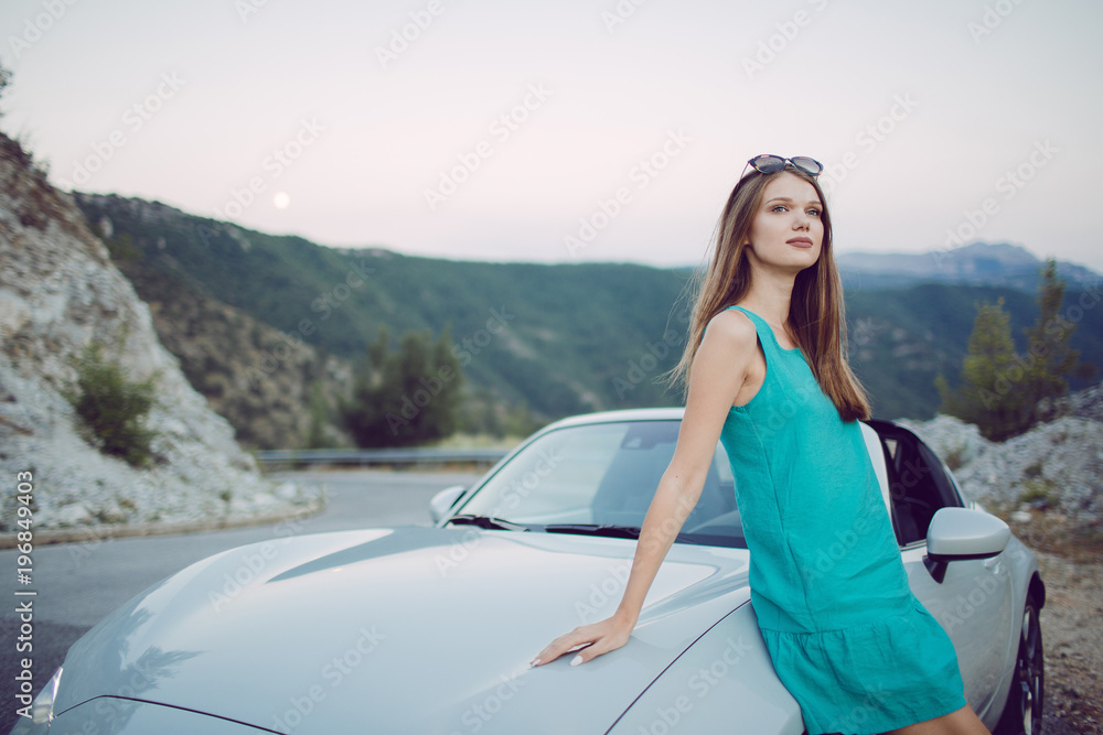 Attractive young woman in a convertible car 