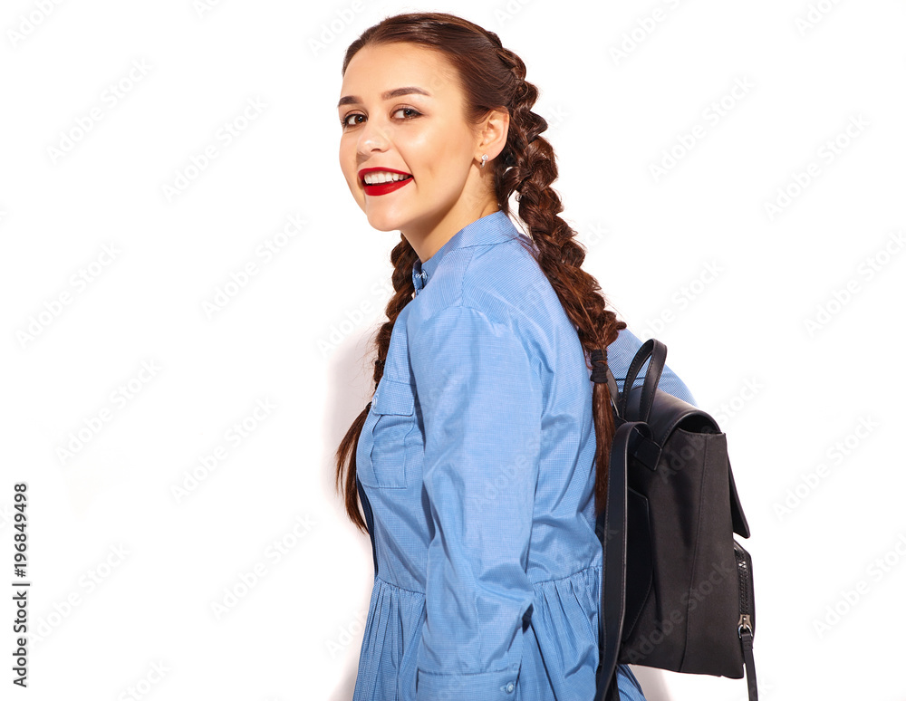 Portrait of young happy smiling woman model with bright makeup and red lips with two horns in hands in summer colorful blue dress and back pack isolated on white Portrait of young happy smiling woman model with bright makeup and red lips with two horns in hands in summer colorful blue dress and back pack isolated on white
