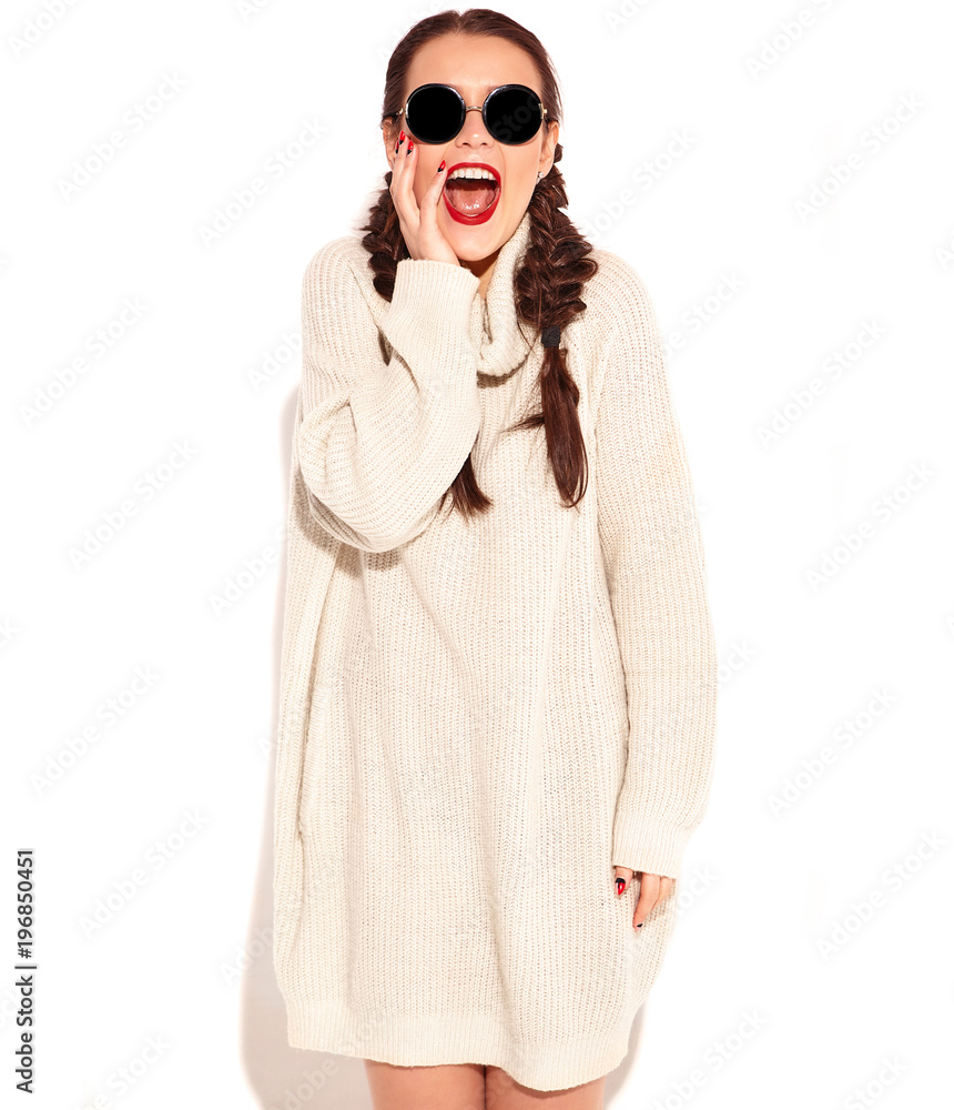 Portrait of young happy smiling woman model with bright makeup and red lips with two horns in summer warm sweater clothes isolated on white. Going crazy Portrait of young happy smiling woman model with bright makeup and red lips with two horns in summer warm sweater clothes isolated on white. Going crazy