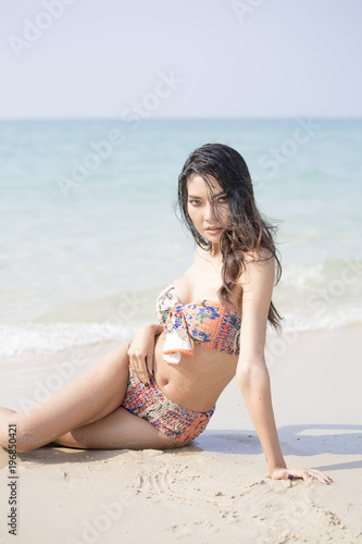 Beautiful asian woman posing at the the ocean.