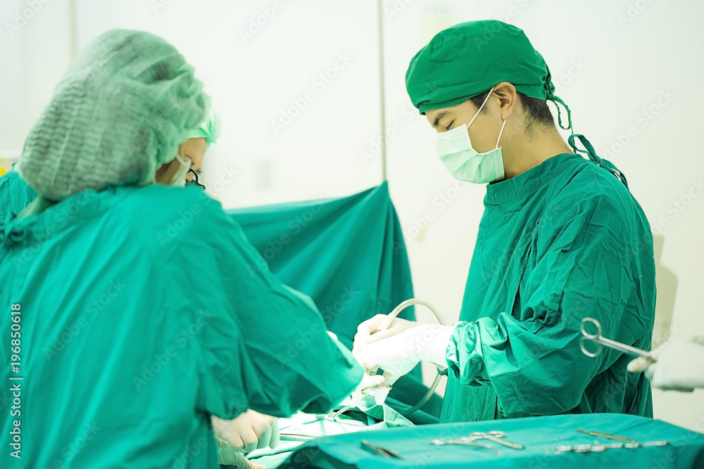 The surgery team working together at the operating room in the hospital. The surgery team working together at the operating room in the hospital.