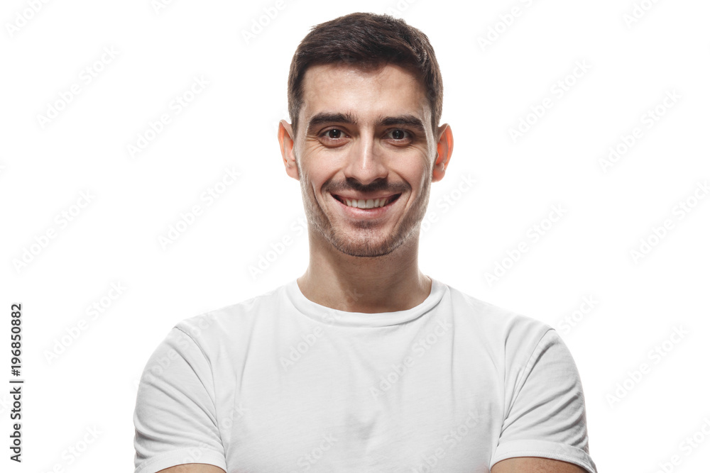 Close up portrait of smiling handsome man in white t-shirt looking at camera, isolated Close up portrait of smiling handsome man in white t-shirt looking at camera, isolated