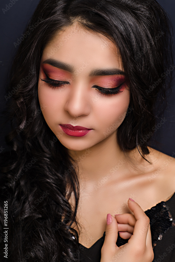 Beautiful brunette girl with red make-up close-up Beautiful brunette girl with red make-up close-up