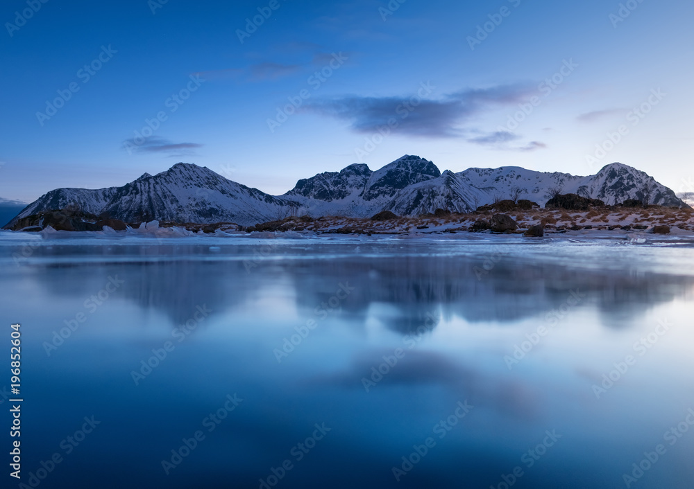 Mountain ridge and reflection in the lake. Natural landscape in the Norway Mountain ridge and reflection in the lake. Natural landscape in the Norway