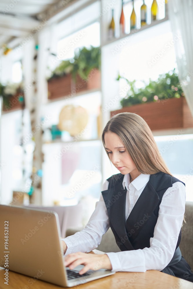 Beautiful young woman using computer while sitting in cafe Beautiful young woman using computer while sitting in cafe