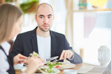 Business people interacting by lunch in restaurant
