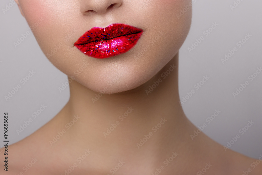 Close-up of woman's lips with bright fashion red glossy makeup. Macro bloody lipgloss make-up