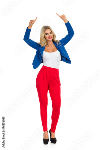 Smiling Sexy Blond Woman Is Standing And Pointing Up
