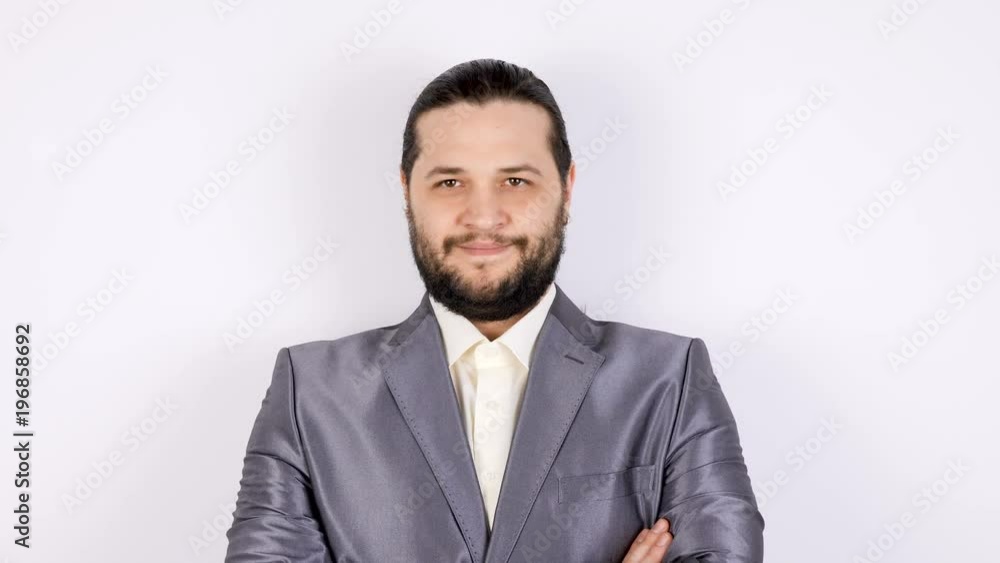 Businessman in formal suit smiling to the camera on gray background Businessman in formal suit smiling to the camera on gray background