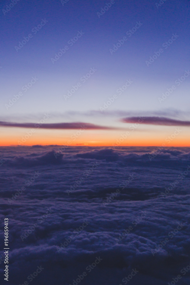 Fototapeta premium sunset with pink and purple tones shot from airplane window seat